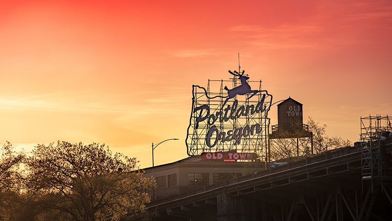 The White Stag sign and Old Town water tower in Portland, OR at dusk