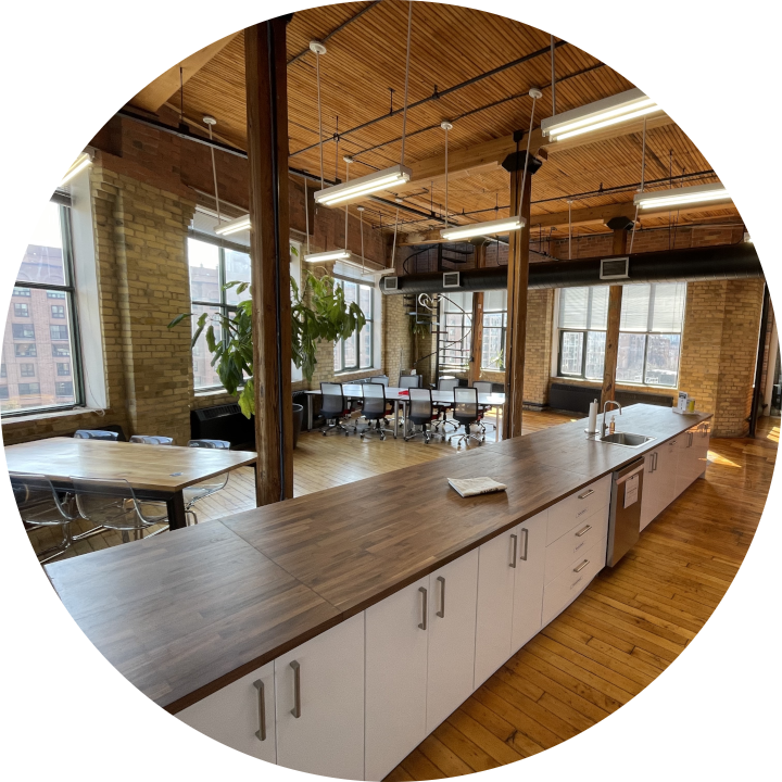 Uncharted's newly renovated kitchen with a large island and several tables for coworking and eating.
