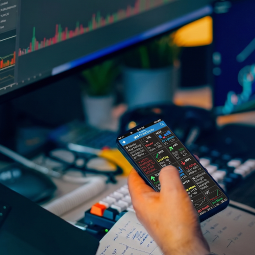 Capital markets professional holding a phone with AI-extracted insights about global equity